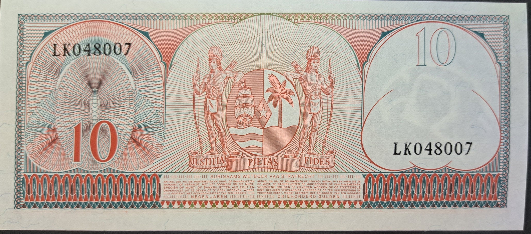 SURINAME 10 Gulden Banknote; P- 121b, UNC; 1963; features a Toucan