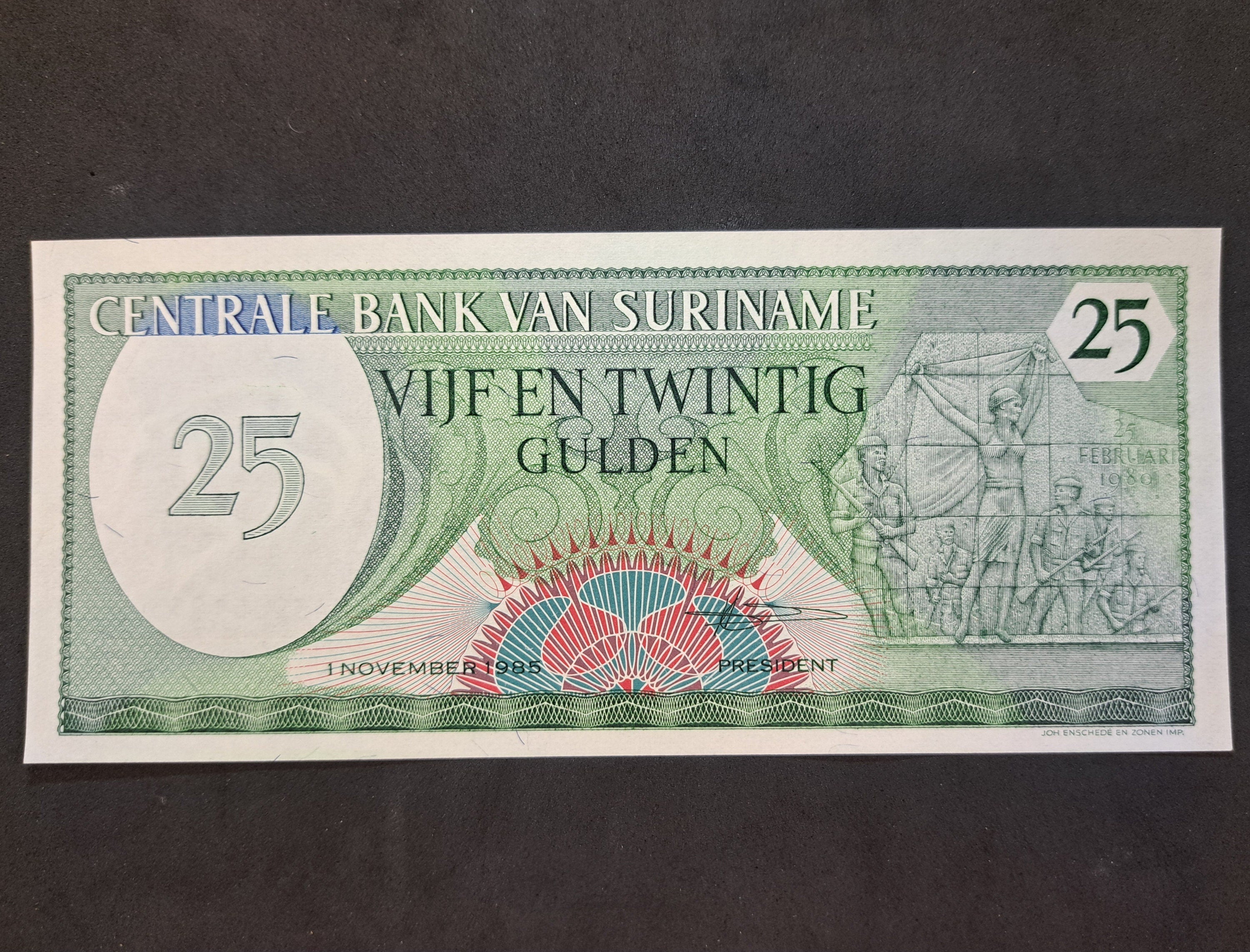 SURINAME 25 Gulden Banknote, P- 127b, UNCIRCULATED, 1985; features a woman and soldiers